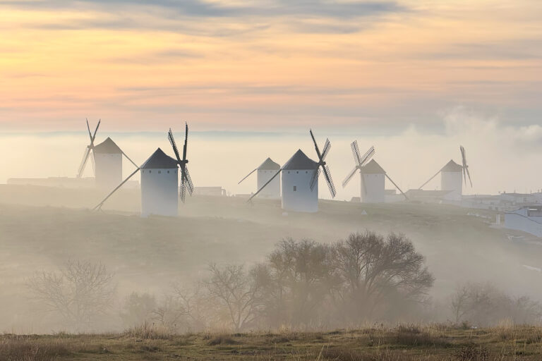 Windmills at dawn in the mist